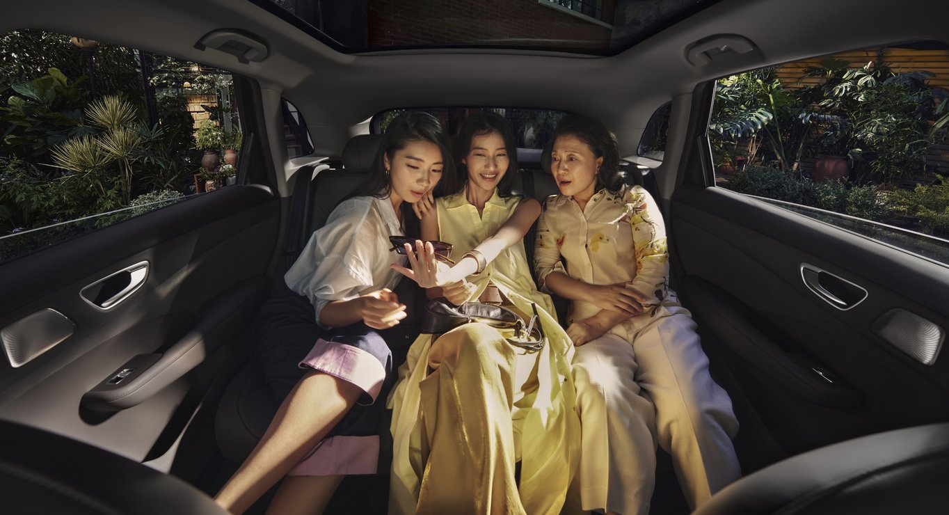 Three women seated together in the rear of the SAIC H5, illustrating the spacious true three-seat configuration