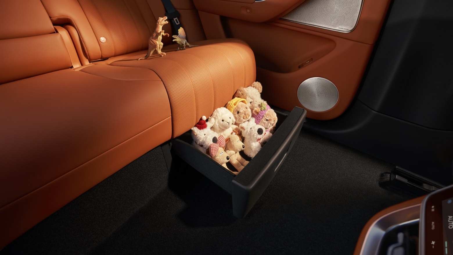 Showcasing the storage space under the second-row seats of the AITO M8 in Red Tea Orange