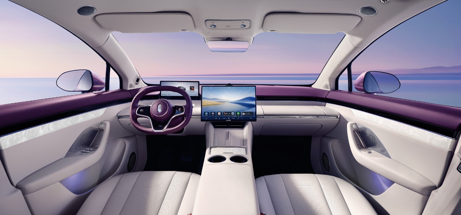 Luxeed R7 front cabin space, showcasing the driver's olive-shaped steering wheel, pilot display, and Roland Purple interior